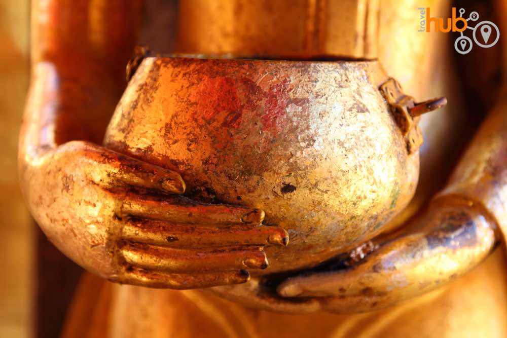 Standing Buddha with alms bowl at the temple