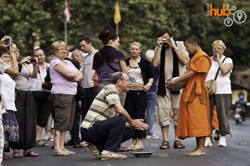 Join the early morning alms rounds of the city monks