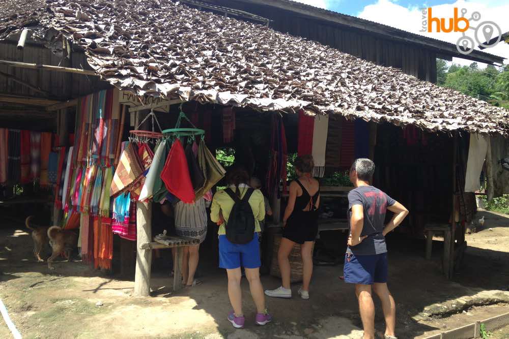 Women in the village sell their handmade fabrics