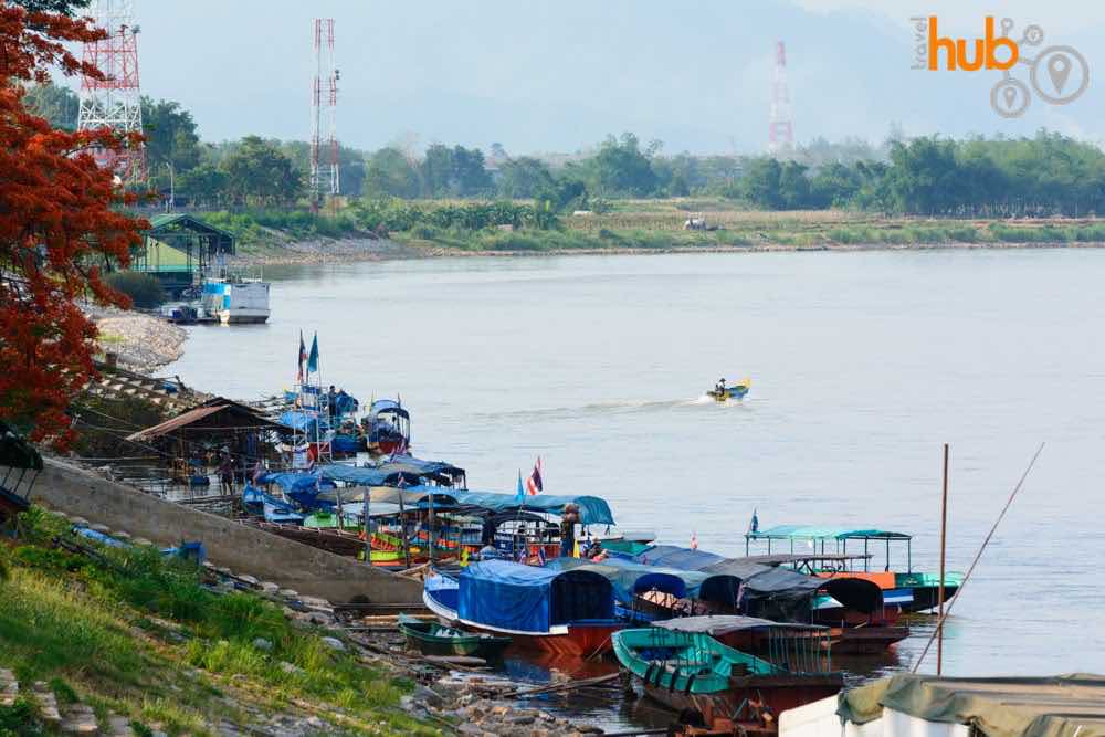 Boats parked up on the Mekong River. This view is looking towards Myanmar