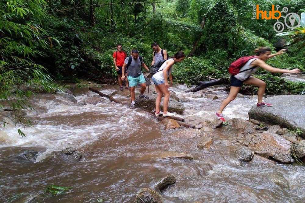 crossing the river on the way to the jungle waterfall